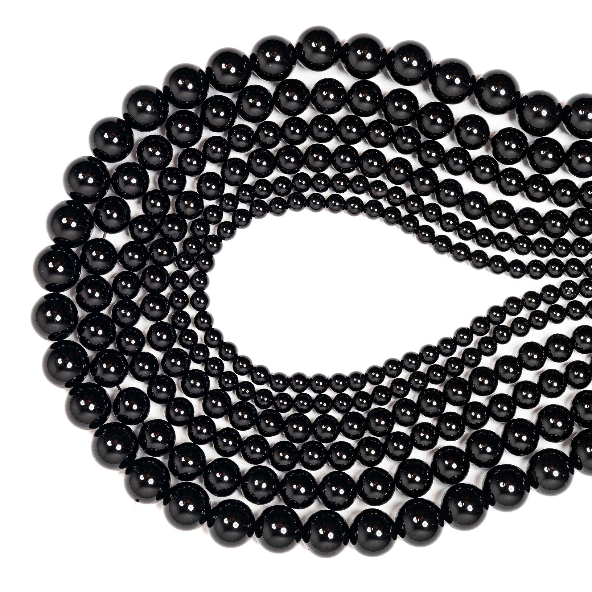 String of black beads on a white background